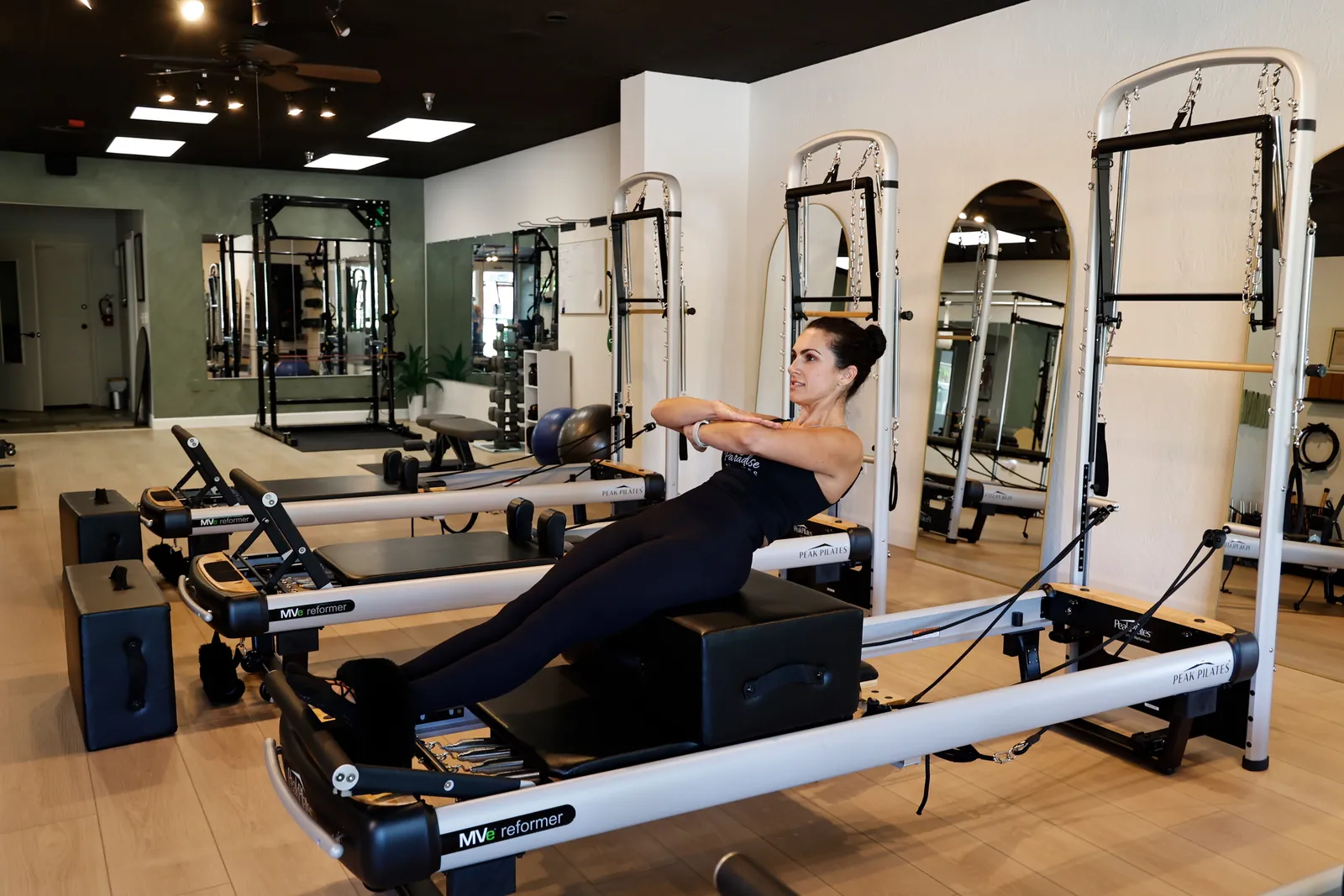 Reformers and equipment on the studio floor at Paradise Pilates