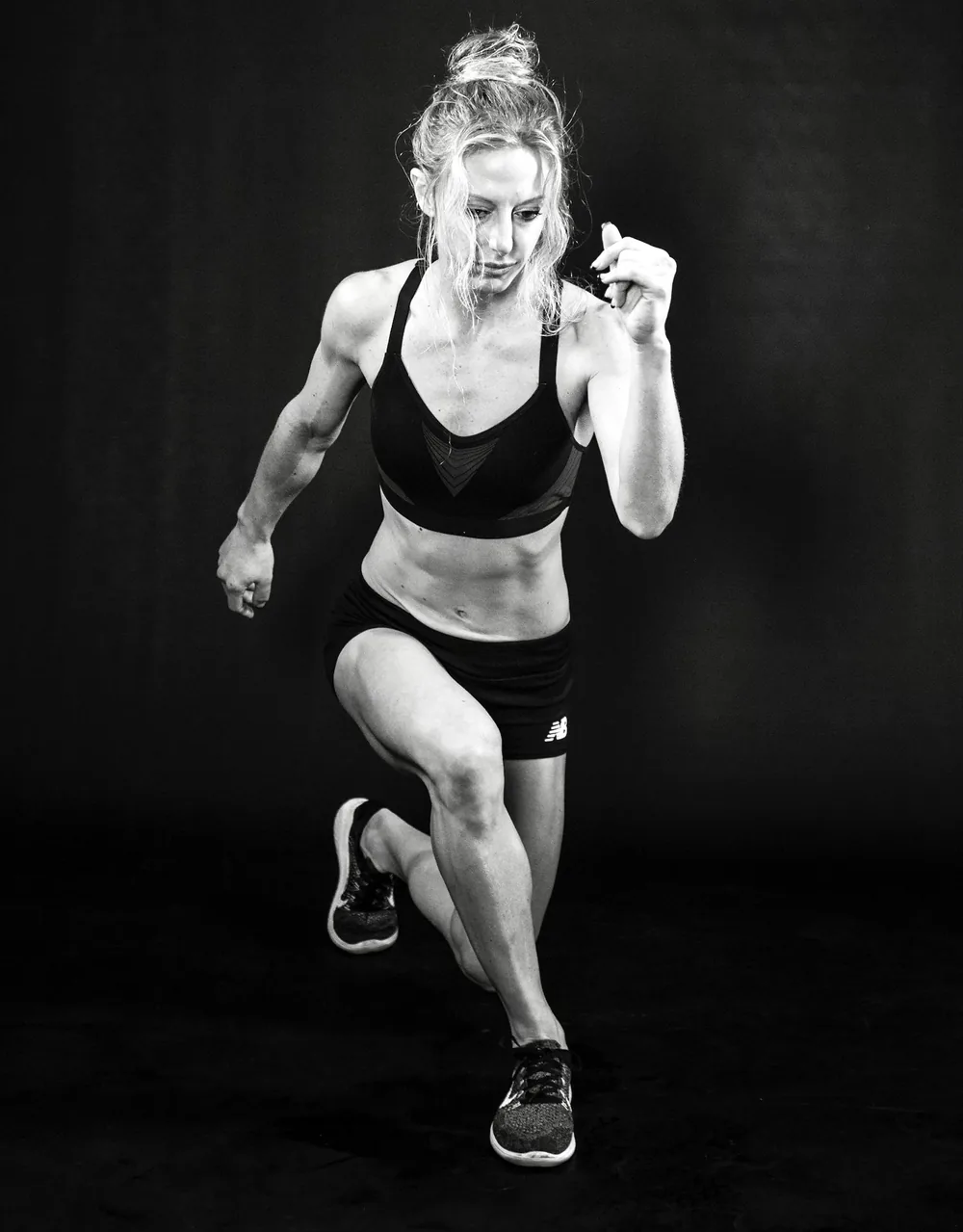 Julia Yesler in a split-stance lunge, black and white portrait
